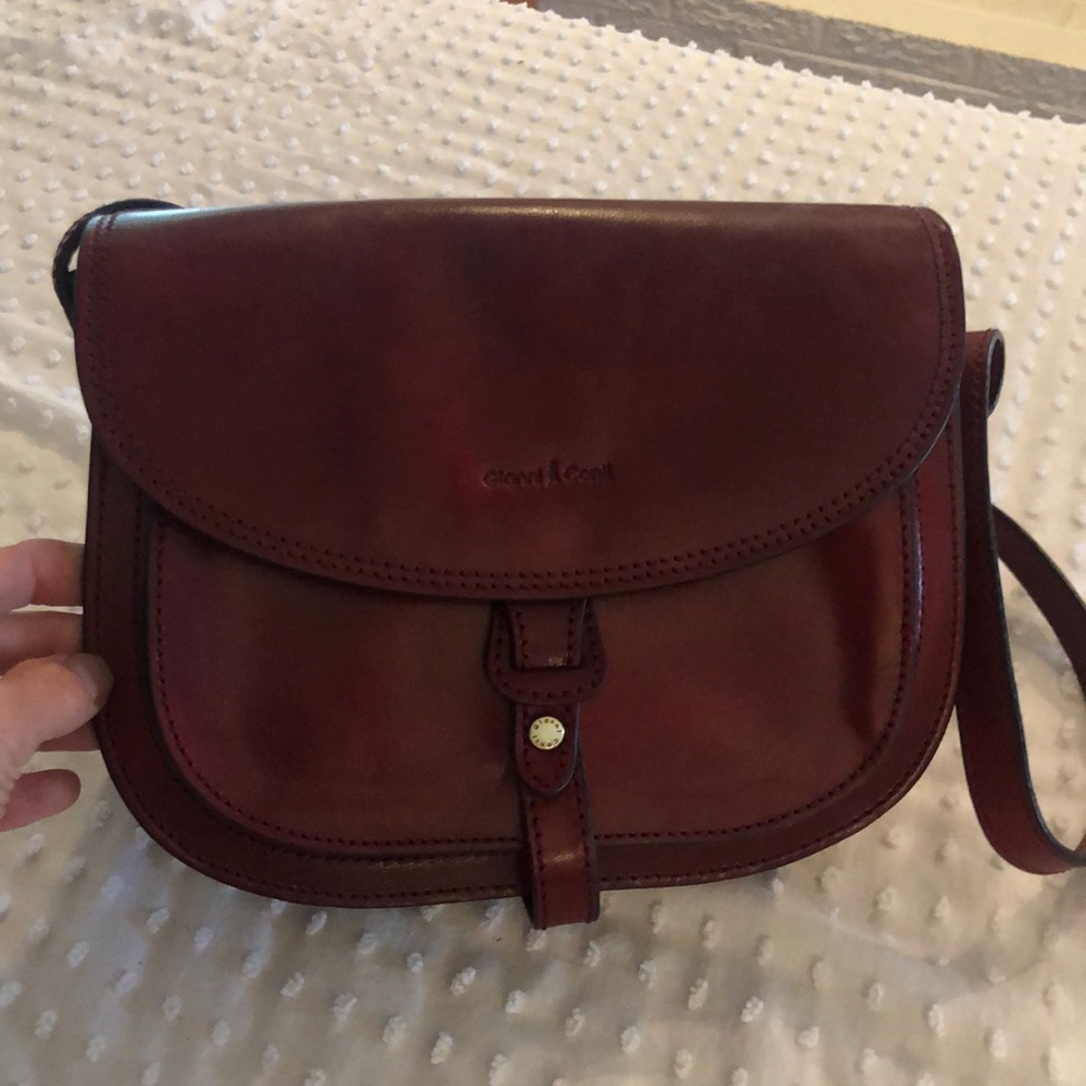 Gianni Conti red leather half flap saddle bag. This is a gorgeous red wine color
